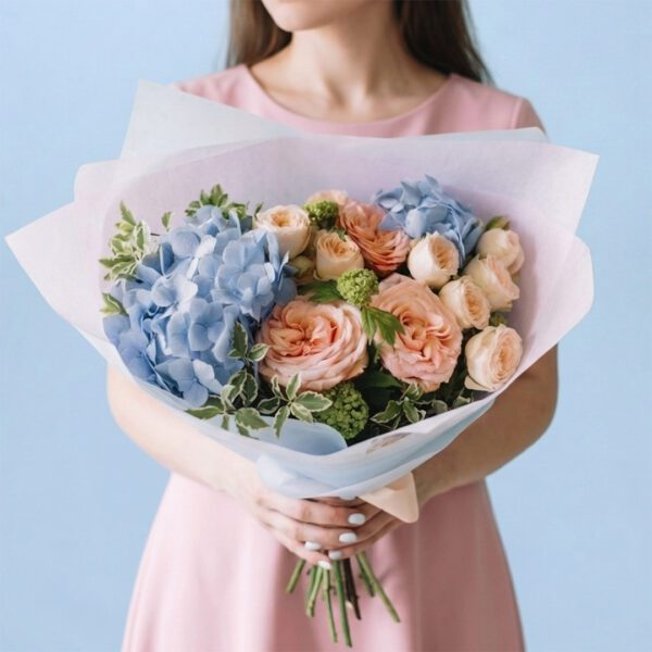 A woman holding a complete bouquet of colorful flowers, smiling gently as she presents it.