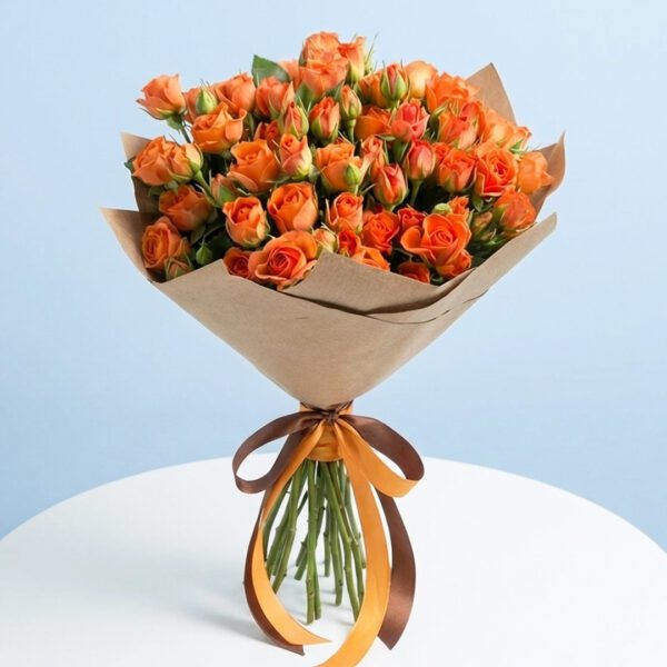 A bouquet of enlightening orange spray roses wrapped in rustic brown paper.