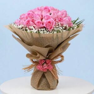 A bouquet of pink roses surrounded by delicate baby's breath, symbolizing joy and beauty.