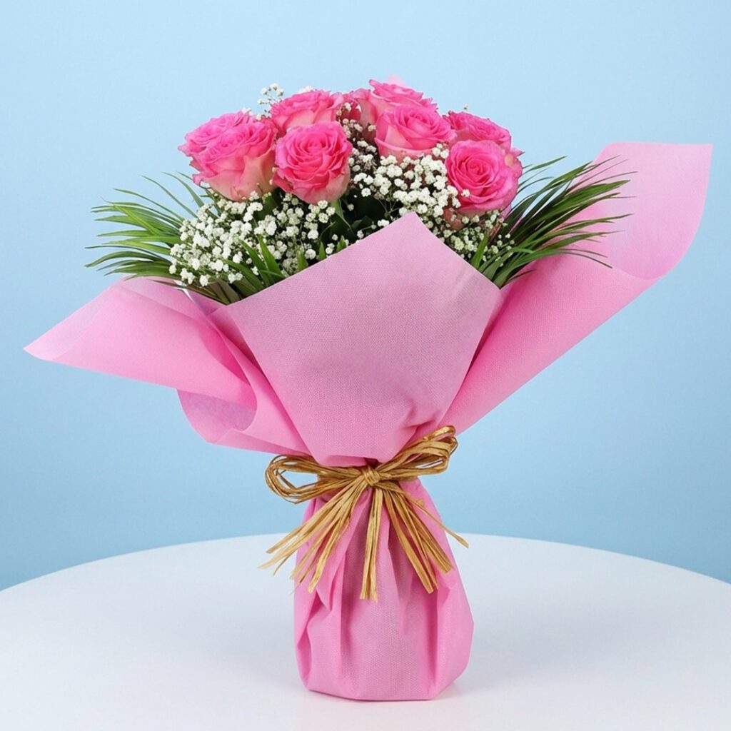A bouquet of pink roses surrounded by delicate baby's breath, titled Pink shower.