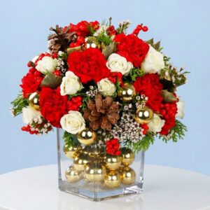 A festive christmas arrangement featuring vibrant red and white flowers, titled "Magical masterpiece."