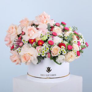 Elegant arrangement of peach roses, Chrysanthemum Santhini, Veronica, and eucalyptus in a round box