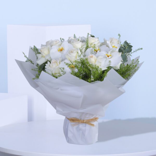 A beautifully wrapped bouquet of white roses and white orchids with thalassic green accents.