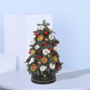 Mini Christmas Tree adorned with cotton blooms, red berries, and dried orange slices—perfect for festive holiday decor