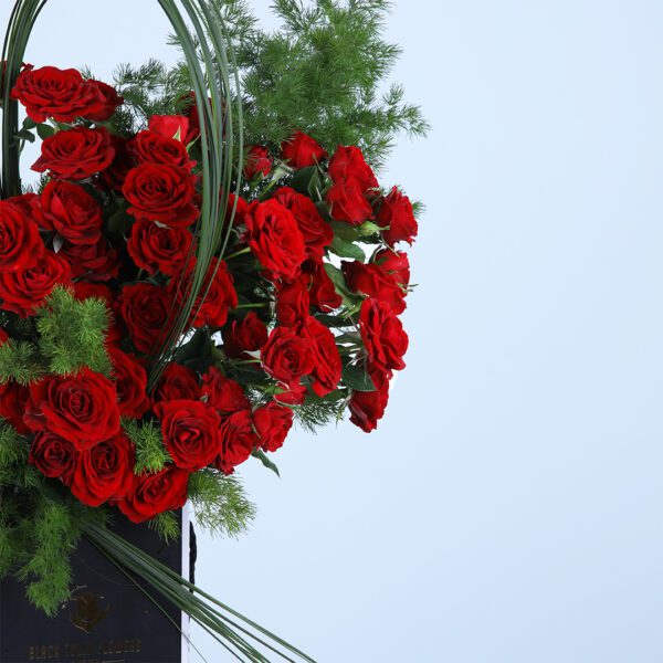 A romantic arrangement of 20 baby red roses and asparagus leaves, perfect for any special occasion.