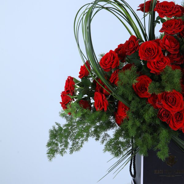 A romantic arrangement of 20 baby red roses and asparagus leaves, perfect for any special occasion.