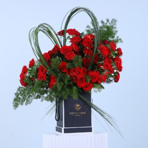 A romantic arrangement of 20 baby red roses and asparagus leaves, perfect for any special occasion.