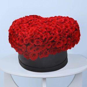 300 red roses arranged in a heart shape within a black gift box.