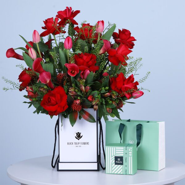 Luxury floral box with 10 red roses, Skimia, Alstroemeria, Calla lilies, Tulips, with a box of Patchi chocolates