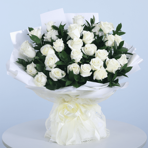 36 white roses with leaves arranged beautifully in an elegant white wrap