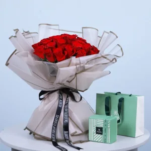 A small, light green cube-shaped box with "Potchi" branding is placed next to the flowers.