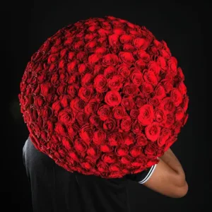 a large bouquet of red roses, which completely obscures their face