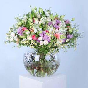 Overflowing with vibrant colors and soft textures, this spring celebration in Vase arrangement showcases a beautiful mix of pink gerbera, pink roses, white ohara lilies, tanacetum, bublurium, white lilies, mathiola, purple lisianthus, and white baby roses.