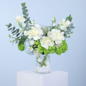 Experience the elegance of our ‘White Rose & Hydrangea Harmony’ flower arrangement, featuring roses, hydrangeas, lisianthus, and eucalyptus in a sleek glass vase. Perfect for gifting or elevating any space.