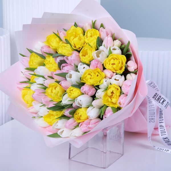 A vibrant bouquet of white, pink, and yellow tulips