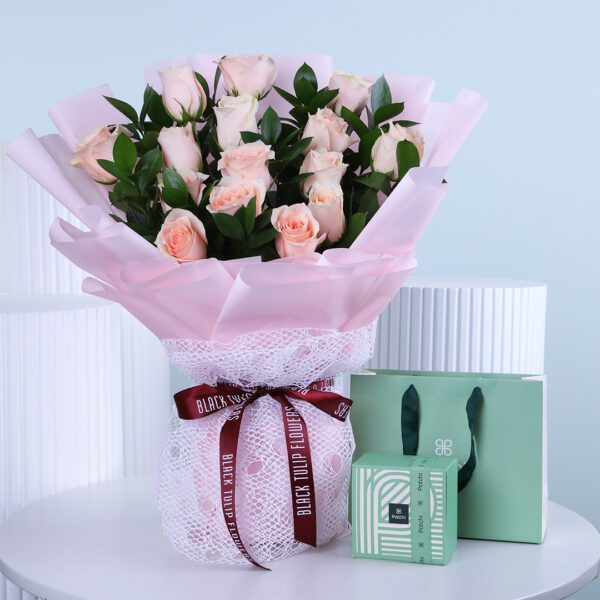 Peach rose bouquet with decorative gift box set on white table