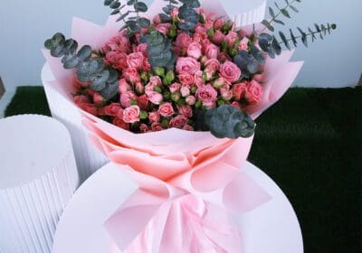 Bouquet of fresh pink spray roses mixed with eucalyptus.