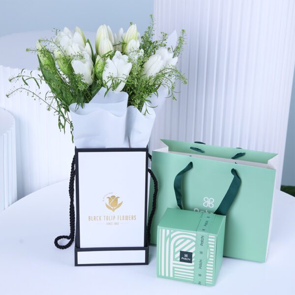 White tulip bouquet with Patchi chocolate box and gift bag