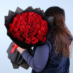 Bouquet of 50 fresh red roses wrapped in elegant black paper