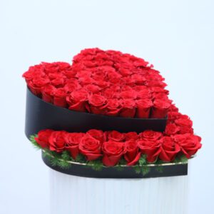 Heart-shaped arrangement of fresh red roses in a sleek black box, ideal for romantic occasions like Valentine's Day or anniversaries.