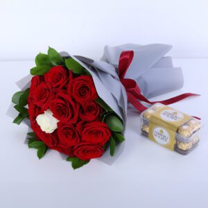 Bouquet of red and white rose with ruscus leaves, with Ferrero Rocher chocolates for special occasions.