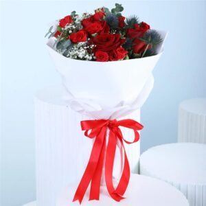 A bouquet featuring 4 red roses, 3 spray roses, and 2 stems of fresh greenery, combining vibrant blooms and lush foliage in a harmonious, beautifully arranged floral display.