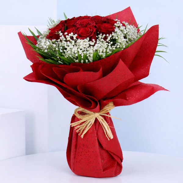 Romantic red rose bouquet and fillers wrapped in red sheet for Valentine gifting